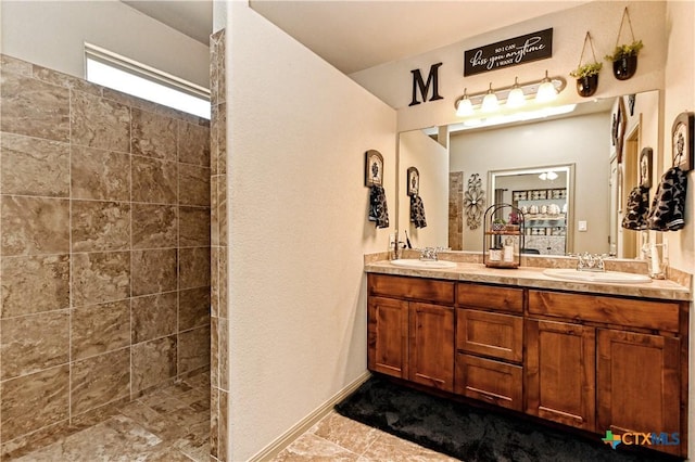 bathroom featuring tiled shower and vanity