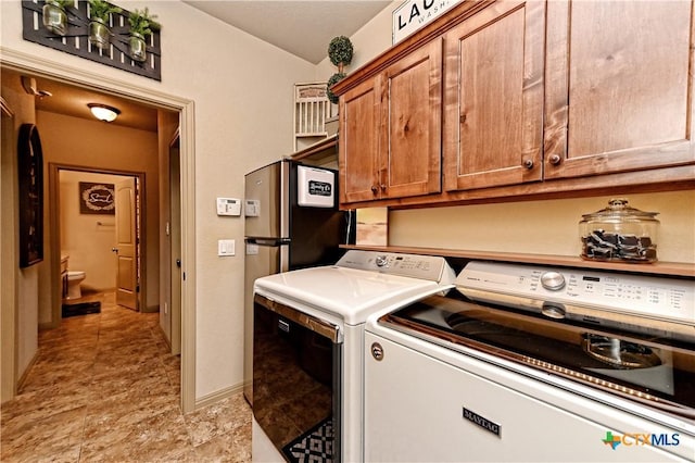 laundry room featuring independent washer and dryer and cabinets