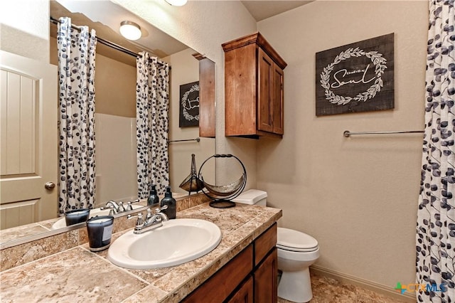 bathroom with toilet and vanity