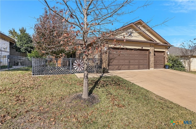 view of front of home featuring a front lawn and a garage