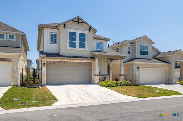 craftsman house with driveway, brick siding, board and batten siding, and an attached garage