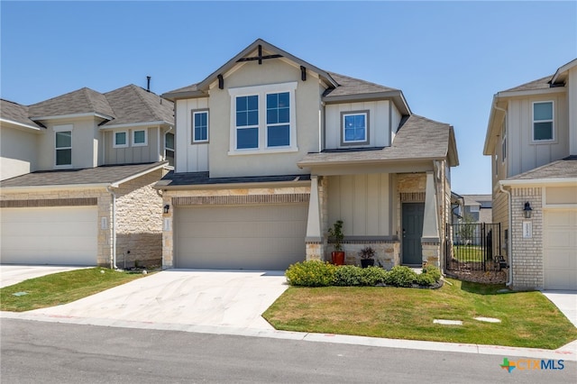 view of front of property with a garage, driveway, board and batten siding, and stone siding