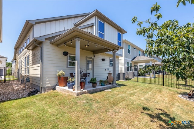 view of front of home with cooling unit, a fenced backyard, a patio, and a front lawn