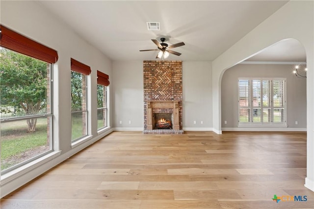 4512 Sunflower Ln, Temple, TX 76502 - unfurnished living room featuring arched walkways, a ceiling fan, healthy amount of natural light, and baseboards