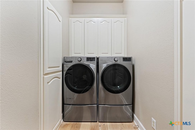 4512 Sunflower Ln, Temple, TX 76502 - laundry area featuring independent washer and dryer, cabinet space, a textured wall, wood finished floors, and baseboards