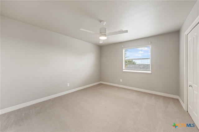 unfurnished bedroom with a closet, light carpet, and ceiling fan