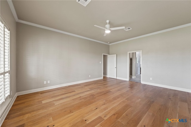 spare room featuring hardwood / wood-style floors, ceiling fan, and crown molding