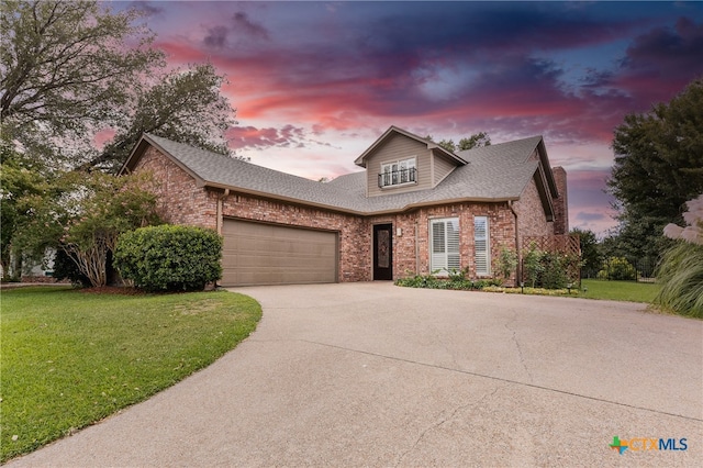 view of property with a lawn and a garage