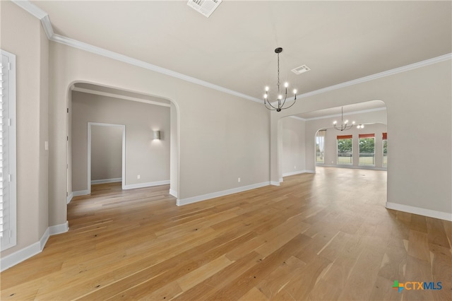 interior space with ornamental molding, a notable chandelier, and light hardwood / wood-style floors