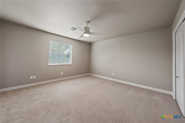 4512 Sunflower Ln, Temple, TX 76502 - spare room with a ceiling fan, light colored carpet, baseboards, and a textured ceiling