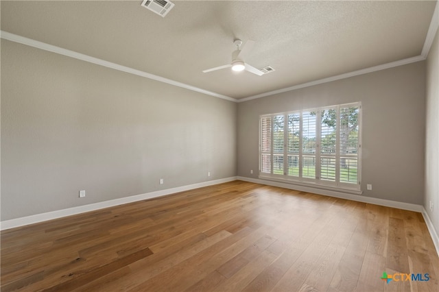 unfurnished room with hardwood / wood-style floors, ceiling fan, a textured ceiling, and ornamental molding