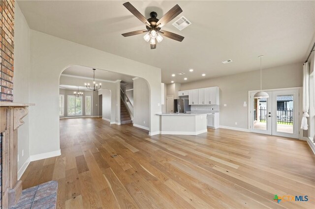 4512 Sunflower Ln, Temple, TX 76502 - unfurnished living room with arched walkways, light wood-type flooring, baseboards, a ceiling fan, and recessed lighting