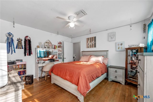 bedroom with hardwood / wood-style floors and ceiling fan