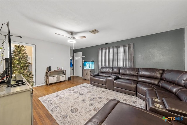 living room with hardwood / wood-style flooring and ceiling fan