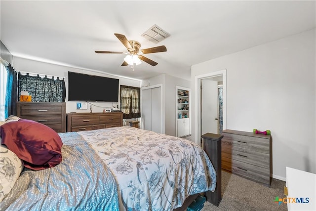 carpeted bedroom with ceiling fan and a closet