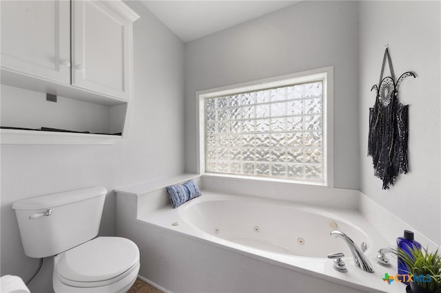 bathroom featuring toilet and a washtub