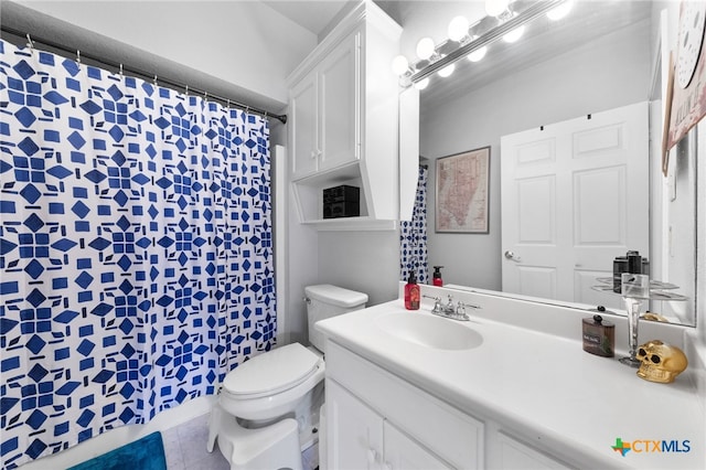 bathroom featuring toilet, vanity, tile patterned floors, and a shower with shower curtain