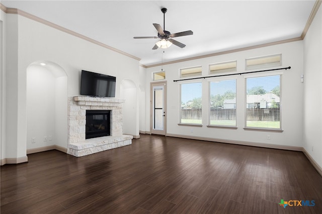 8235 Shining Elk, Garden Ridge, TX 78266 - unfurnished living room featuring ceiling fan, a fireplace, ornamental molding, dark wood-style flooring, and arched walkways