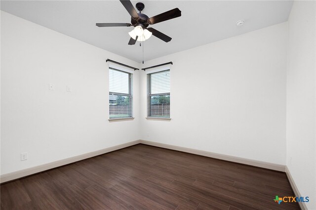 8235 Shining Elk, Garden Ridge, TX 78266 - spare room featuring dark wood-type flooring, ceiling fan, and a smoke detector