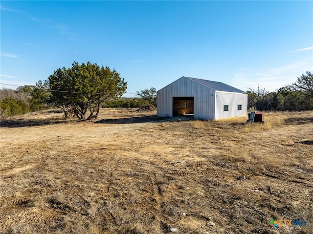 view of yard with a rural view and an outdoor structure