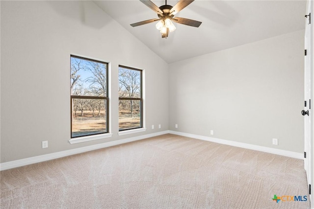 unfurnished room featuring light carpet, vaulted ceiling, and ceiling fan