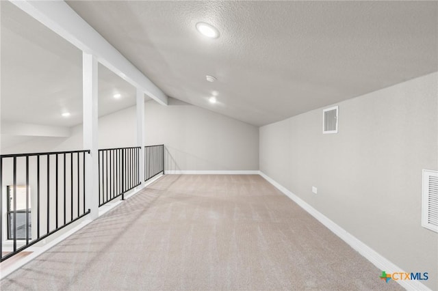 basement with a textured ceiling and carpet flooring