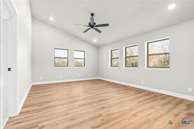 unfurnished room with light hardwood / wood-style floors, ceiling fan, and vaulted ceiling