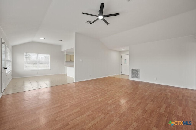 unfurnished living room featuring ceiling fan, lofted ceiling, and light hardwood / wood-style flooring