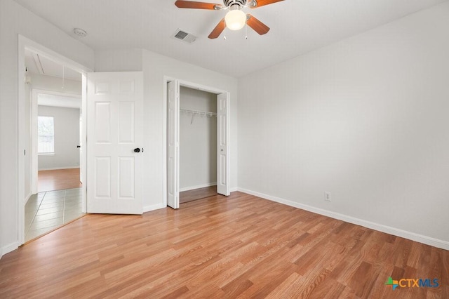 unfurnished bedroom with ceiling fan, a closet, and light hardwood / wood-style flooring