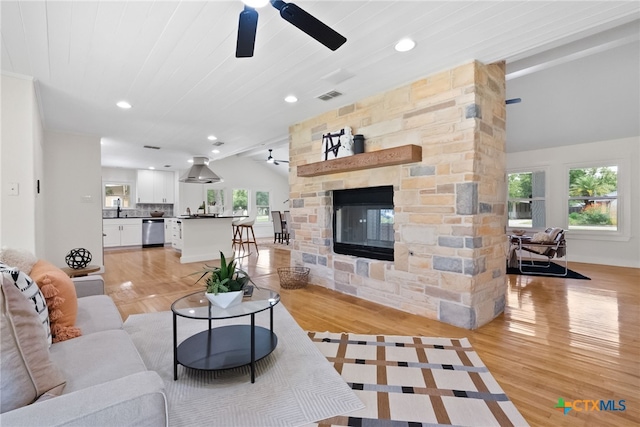 456 Magazine Ave, New Braunfels, TX 78130 - living area featuring ceiling fan, lofted ceiling, a fireplace, light wood-style floors, and recessed lighting