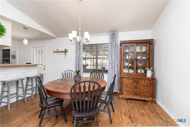 2210 Buckskin Trl, Temple, TX 76502 - dining room featuring wood finished floors, a chandelier, and lofted ceiling