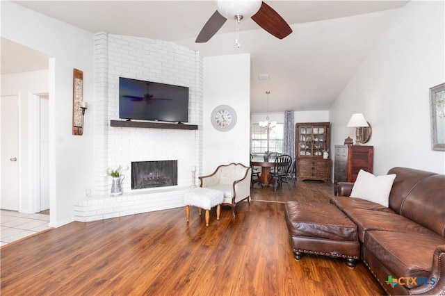 2210 Buckskin Trl, Temple, TX 76502 - living area featuring a ceiling fan, wood finished floors, a brick fireplace, and a chandelier