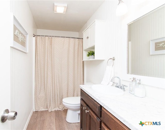 2210 Buckskin Trl, Temple, TX 76502 - bathroom with vanity, toilet, wood finished floors, and a shower with shower curtain
