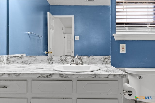 bathroom with vanity and toilet