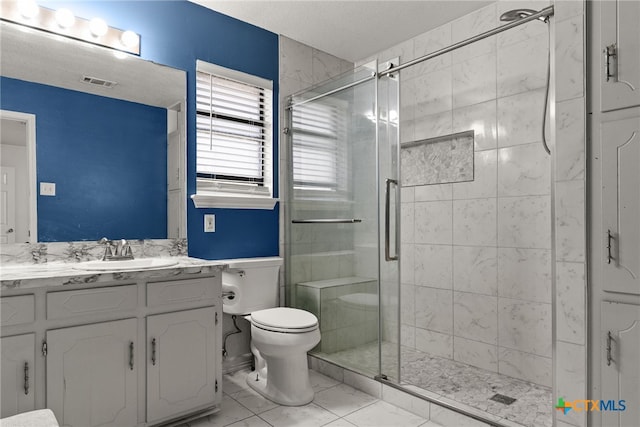 bathroom with walk in shower, vanity, and toilet