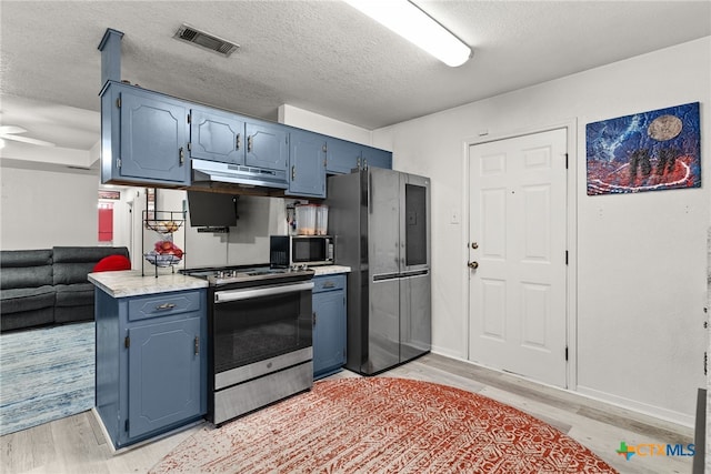 kitchen with ceiling fan, appliances with stainless steel finishes, a textured ceiling, and light hardwood / wood-style floors