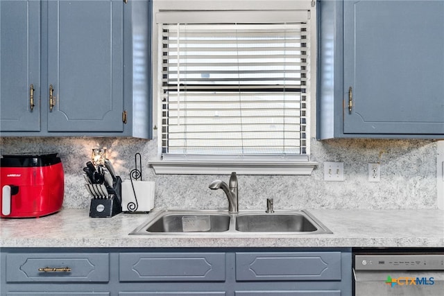 kitchen featuring tasteful backsplash, stainless steel dishwasher, a wealth of natural light, and sink