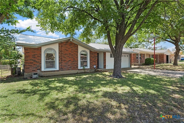 ranch-style home featuring a garage, central AC, and a front yard