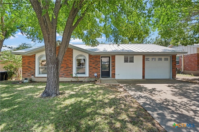 single story home featuring a garage and a front yard