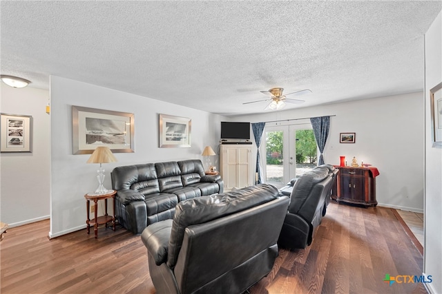 living room with a textured ceiling, wood-type flooring, and french doors