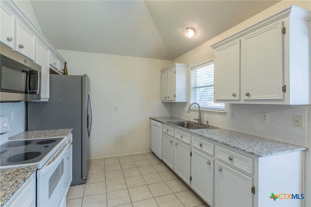 21 Artesian Dr, Belton, TX 76513 - kitchen with white appliances, decorative backsplash, vaulted ceiling, white cabinetry, and light tile patterned floors