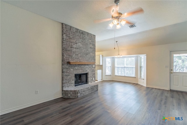 21 Artesian Dr, Belton, TX 76513 - unfurnished living room with dark wood-style floors, a ceiling fan, a fireplace, a chandelier, and vaulted ceiling