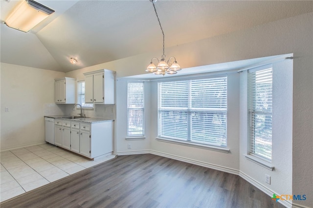 21 Artesian Dr, Belton, TX 76513 - kitchen featuring light wood-type flooring, lofted ceiling, a chandelier, dishwasher, and plenty of natural light