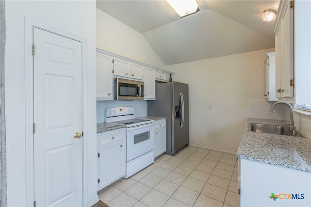 21 Artesian Dr, Belton, TX 76513 - kitchen featuring stainless steel appliances, tasteful backsplash, vaulted ceiling, white cabinets, and light tile patterned flooring