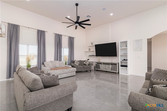 living room featuring a high ceiling and ceiling fan