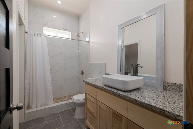 bathroom featuring vanity, curtained shower, and toilet