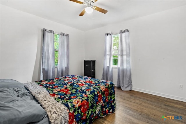 bedroom featuring baseboards, a ceiling fan, and wood finished floors