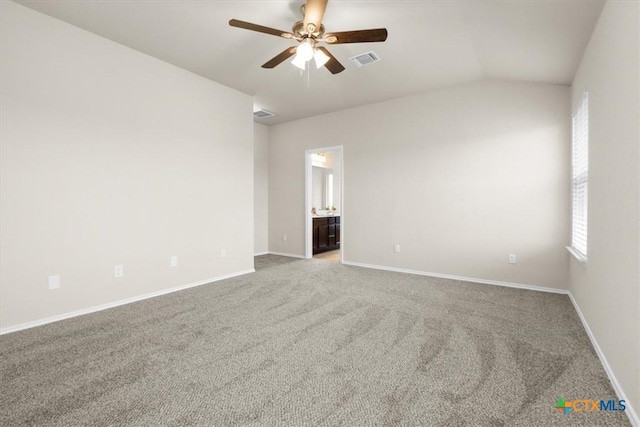 carpeted empty room with vaulted ceiling and ceiling fan