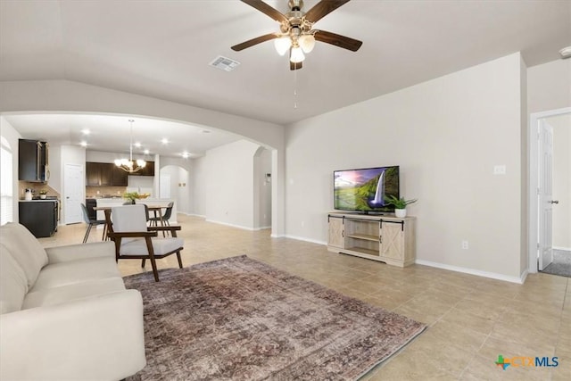 living room featuring ceiling fan with notable chandelier and lofted ceiling