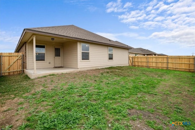 back of house featuring a yard and a patio